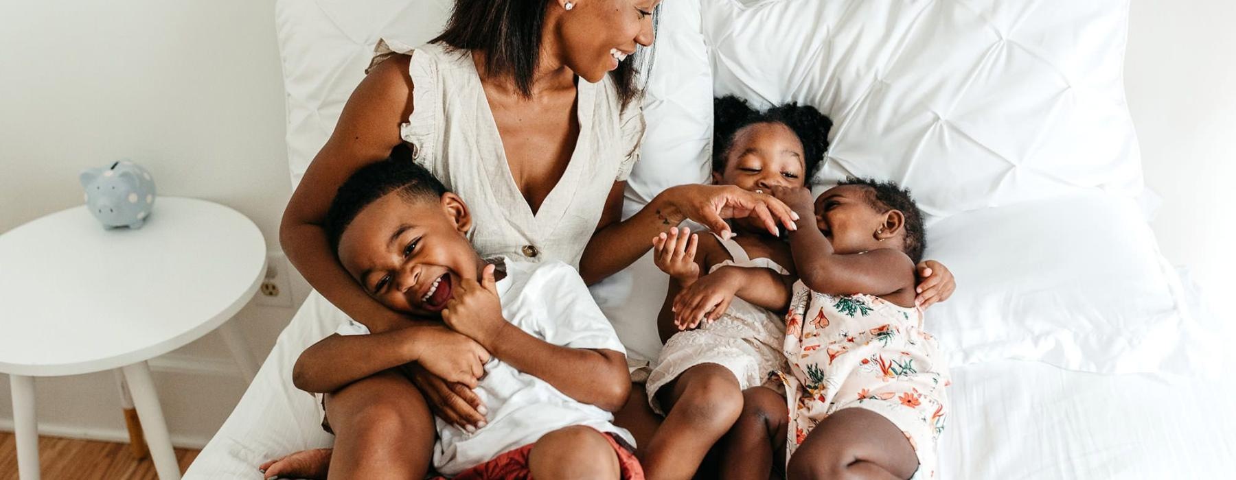 a woman on a bed with her children